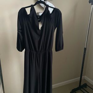 Jumpsuit with cutout shoulder, wide cropped leg and sash.